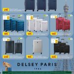Al Meera Qatar luggage sale featuring Delsey Paris hard and soft shell trolley suitcases in various sizes and colors.