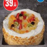 Round mixed fruit cake with cream and almond flakes at Monoprix.